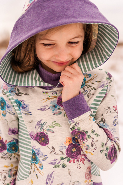 Hooded sweater with turtle neck, princess seams, pockets and split hem.