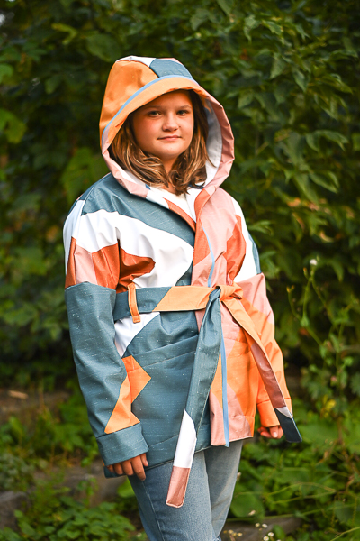 Soft shell hooded jacket pattern with long cuffed sleeve, belt and pockets.