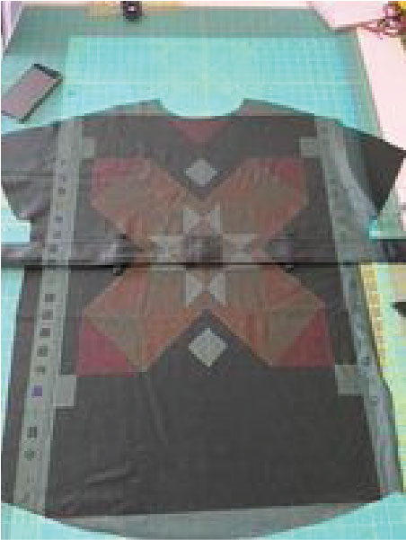 Using projector to plan quilted sewing project for fall coat.